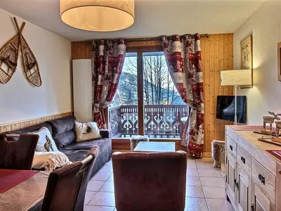 a living room with a couch and a window at Appartement 2 chambres, pied de piste, parking, 6 personnes - FR-1-836-18 in Arâches-la-Frasse