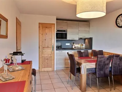 a kitchen and dining room with a table and chairs at Appartement 2 chambres, pied de piste, parking, 6 personnes - FR-1-836-18 in Arâches-la-Frasse