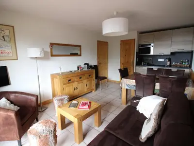 a living room with a couch and a table at Appartement 2 chambres, pied de piste, parking, 6 personnes - FR-1-836-18 in Arâches-la-Frasse