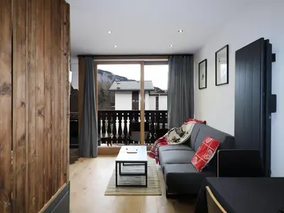a living room with a couch and a table at Studio rénové et cosy avec Wifi et animaux admis proche centre - FR-1-836-21 in Arâches-la-Frasse