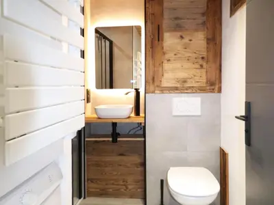 a mirror in a bathroom with a leafy wall at Studio rénové et cosy avec Wifi et animaux admis proche centre - FR-1-836-21 in Arâches-la-Frasse