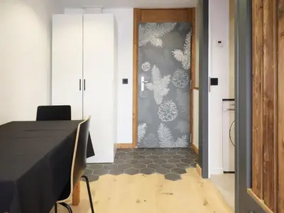 a dining room with a table and a door at Studio rénové et cosy avec Wifi et animaux admis proche centre - FR-1-836-21 in Arâches-la-Frasse