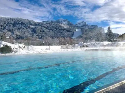 a pool of blue water with a snow covered mountain at Appartement 2 chambres - 6 pers - Centre station - FR-1-836-17 in Arâches-la-Frasse