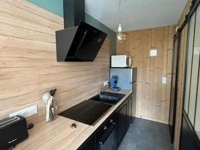 a small kitchen with a sink and a refrigerator at Appartement rénové 2 pièces, centre station, garage, animaux admis - FR-1-836-24 in Arâches-la-Frasse