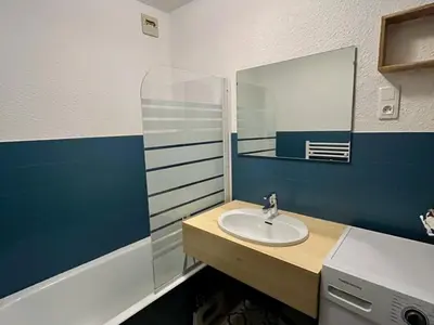 a bathroom with a sink and a mirror at Appartement rénové 2 pièces, centre station, garage, animaux admis - FR-1-836-24 in Arâches-la-Frasse