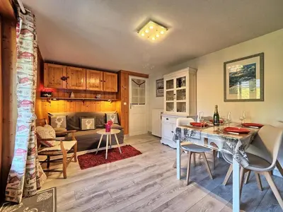 a kitchen and living room with a table and chairs at Charmant 2 pièces aux Carroz d'Arâches avec parking et WIFI - 4 personnes - FR-1-836-23 in Arâches-la-Frasse