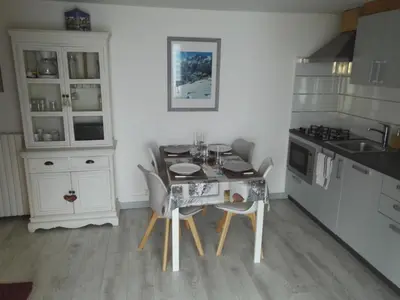 a kitchen with a table and chairs in a kitchen at Charmant 2 pièces aux Carroz d'Arâches avec parking et WIFI - 4 personnes - FR-1-836-23 in Arâches-la-Frasse