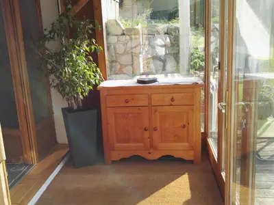 a wooden cabinet in front of a window at Charmant 2 pièces aux Carroz d'Arâches avec parking et WIFI - 4 personnes - FR-1-836-23 in Arâches-la-Frasse
