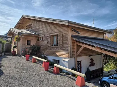 a wooden house with orange cones in front of it at Charmant 2 pièces aux Carroz d'Arâches avec parking et WIFI - 4 personnes - FR-1-836-23 in Arâches-la-Frasse