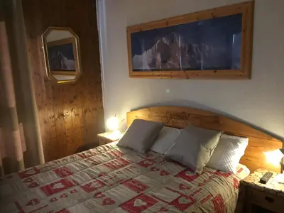 a bedroom with a bed with two pillows on it at Chamonix Central Panoramic Apartment & Private Sauna in Chamonix-Mont-Blanc