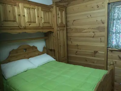 a bedroom with a bed in a log cabin at Chamonix Central Panoramic Apartment & Private Sauna in Chamonix-Mont-Blanc