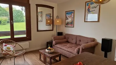 a living room with a couch and a table at Cristaux Studio, with view to Mont Blanc in Combloux