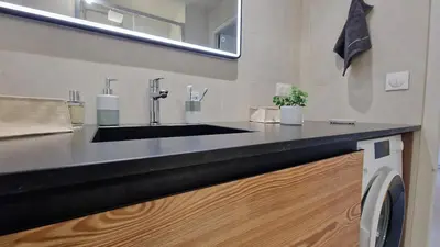 a bathroom with a black sink and a mirror at Cristaux Studio, with view to Mont Blanc in Combloux