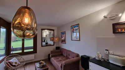a living room with a couch and a large orb at Cristaux Studio, with view to Mont Blanc in Combloux