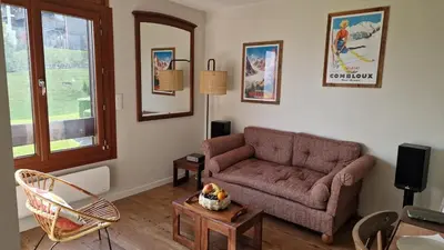 a living room with a couch and a table at Cristaux Studio, with view to Mont Blanc in Combloux