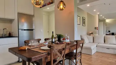 a kitchen and living room with a wooden table and chairs at Cristaux Studio, with view to Mont Blanc in Combloux