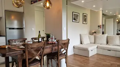 a kitchen and living room with a table and a couch at Cristaux Studio, with view to Mont Blanc in Combloux