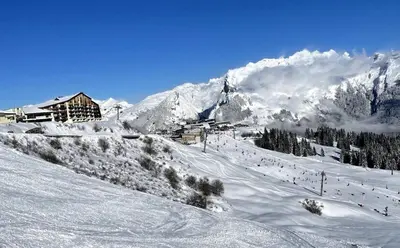 a snow covered mountain with a resort in the background at Appartement Samoëns 1600 in Samoëns