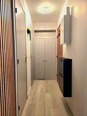 a hallway with a door leading to a kitchen at Appartement Samoëns 1600 in Samoëns