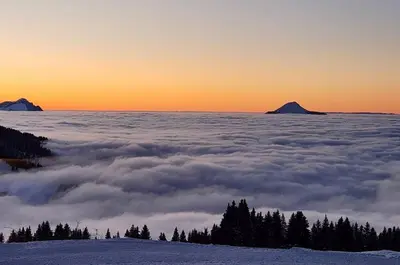 a view of a sea of clouds with mountains in the background at Appartement Samoëns 1600 in Samoëns
