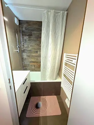a small bathroom with a shower and a sink at Appartement Samoëns 1600 in Samoëns