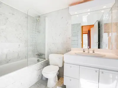 a white bathroom with a sink and a tub at Apartment Bel Alp-1 by Interhome in Saint-Gervais-les-Bains