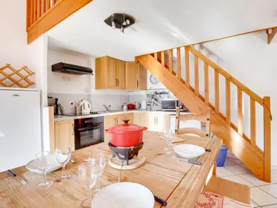 a kitchen with wooden cabinets and a stove top oven at Apartment Bel Alp-1 by Interhome in Saint-Gervais-les-Bains