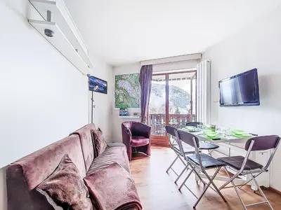 a living room with a couch and a chair at Studio L'aiguille noire by Interhome in Bionnay