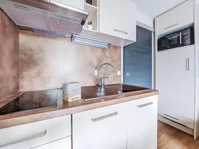 a kitchen with white cabinets and a sink at Studio L'aiguille noire by Interhome in Bionnay