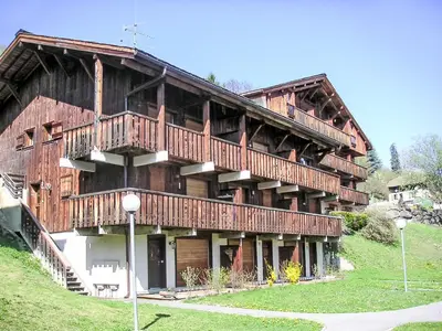 a log house with a swimming pool next to it at Studio Les Grets-13 by Interhome in Saint-Gervais-les-Bains