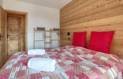 a bedroom with a large bed with red pillows at Apartment Safi in Chamonix-Mont-Blanc