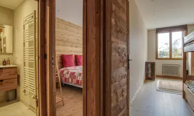 a bedroom with a bed and a wooden wall at Apartment Safi in Chamonix-Mont-Blanc