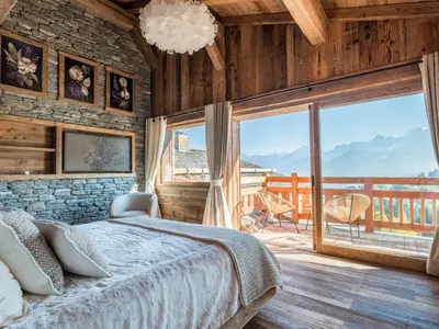 a bedroom with a bed and a large window at Chalet Marianna I Le Chalet Club in Combloux