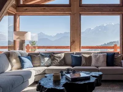 a living room with a couch and a table at Chalet Marianna I Le Chalet Club in Combloux