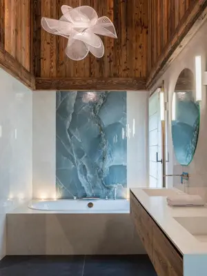 a bathroom with a tub and a sink at Chalet Marianna I Le Chalet Club in Combloux