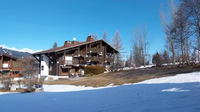 a large building with snow in front of it at F1 tout confort Megève skis aux pieds in Megève