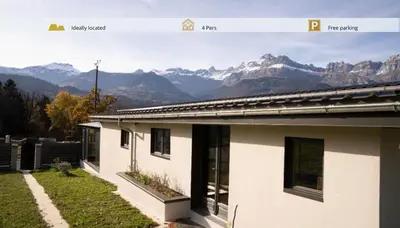 a picture of a house with mountains in the background at Maison nature, ski, randos in Passy