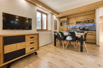 a kitchen and dining room with a table and chairs at Nid du Pic - Cozy alpine retreat with private garden in Chamonix in Chamonix-Mont-Blanc