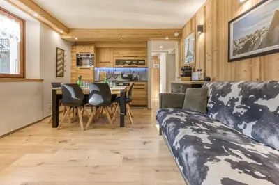 a kitchen and dining room with a table and chairs at Nid du Pic - Cozy alpine retreat with private garden in Chamonix in Chamonix-Mont-Blanc