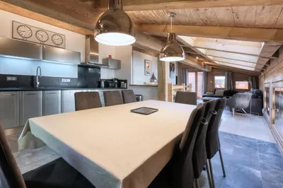 a kitchen and dining room with a table and chairs at Le Cédron, demi-chalet centre pièton Megève in Megève