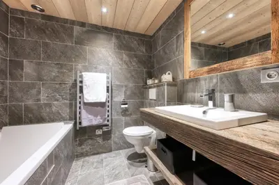 a bathroom with a sink and a toilet and a tub at Le Cédron, demi-chalet centre pièton Megève in Megève