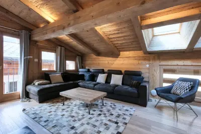a living room with a couch and a table at Le Cédron, demi-chalet centre pièton Megève in Megève