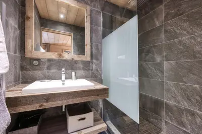 a bathroom with a sink and a mirror at Le Cédron, demi-chalet centre pièton Megève in Megève