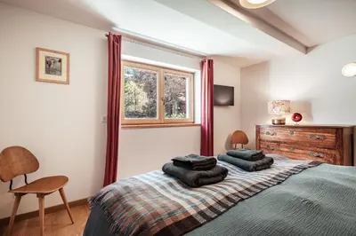 a bedroom with a bed with two pillows on it at Chalet Mont Plaisir - Au pied des Drus in Chamonix-Mont-Blanc