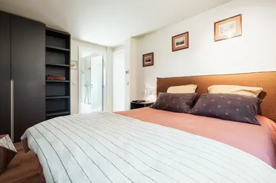 a bedroom with a large bed with two pillows at Chalet Mont Plaisir - Au pied des Drus in Chamonix-Mont-Blanc