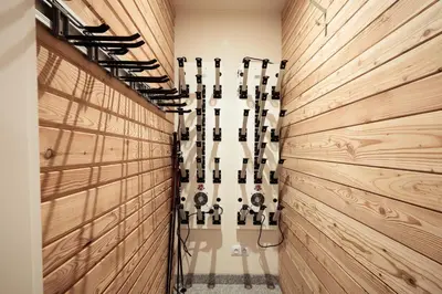 a gym with wooden walls and a row of exercise equipment at Chalet Mont Plaisir - Au pied des Drus in Chamonix-Mont-Blanc