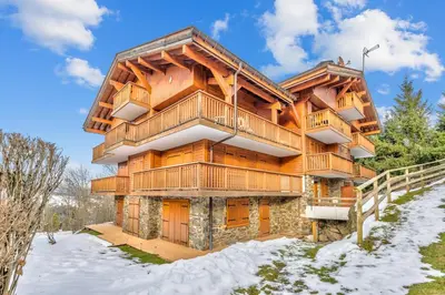 a log home in the winter with snow on the ground at Appartement Mercier - Welkeys in Megève