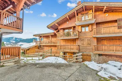 a large wooden building with balconies on it at Appartement Mercier - Welkeys in Megève
