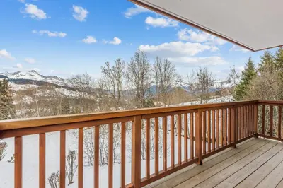 a balcony with a view of the snow covered mountains at Appartement Mercier - Welkeys in Megève