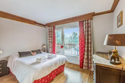 a bedroom with a bed and a window at Appartement Mercier - Welkeys in Megève